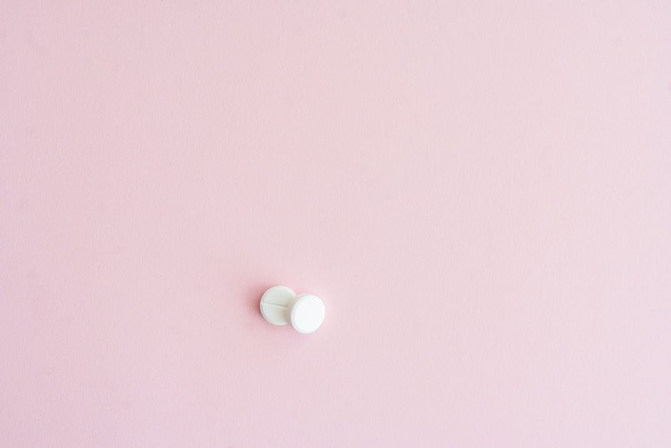 Two white tablets on a soft pink background, showcasing minimalist design.