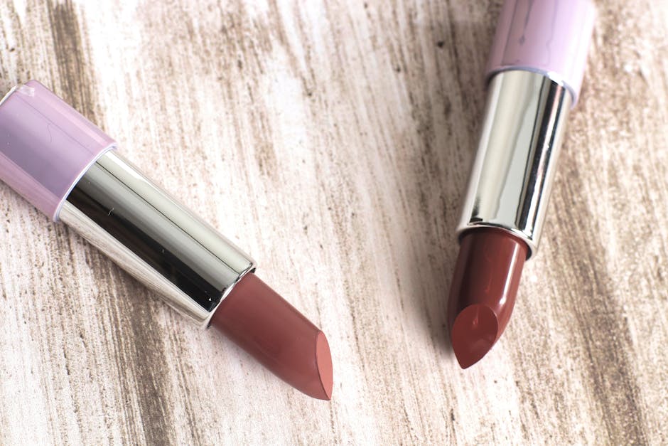 Two elegant lipsticks showcased on a wooden surface, perfect for makeup and cosmetic themes.