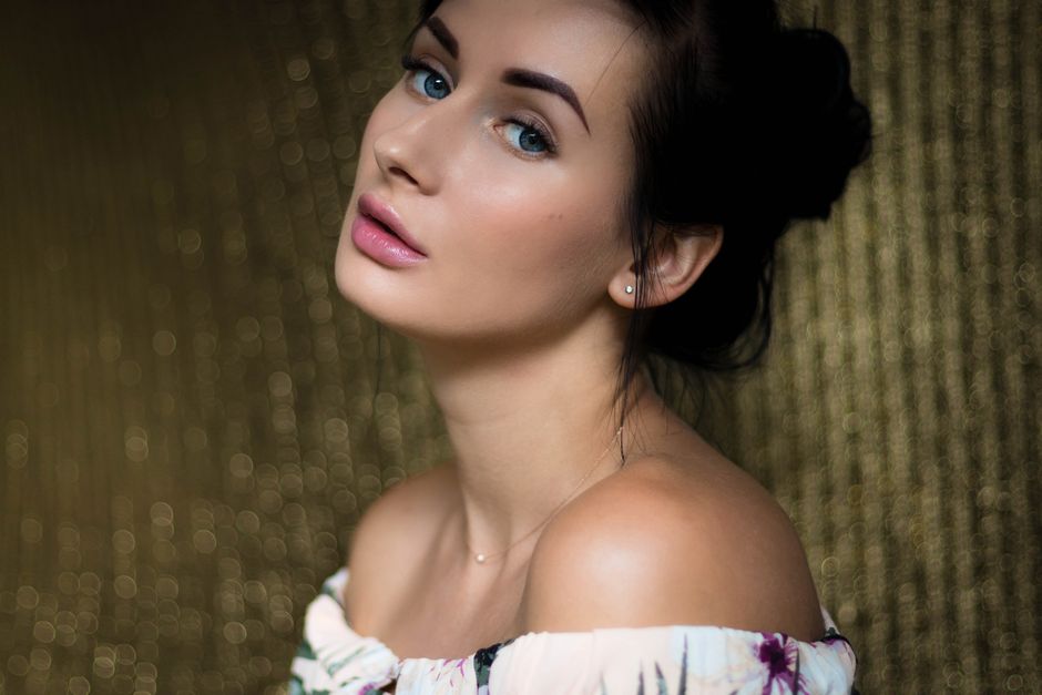 Stunning portrait of a woman with serene expression and soft lighting, evoking beauty and